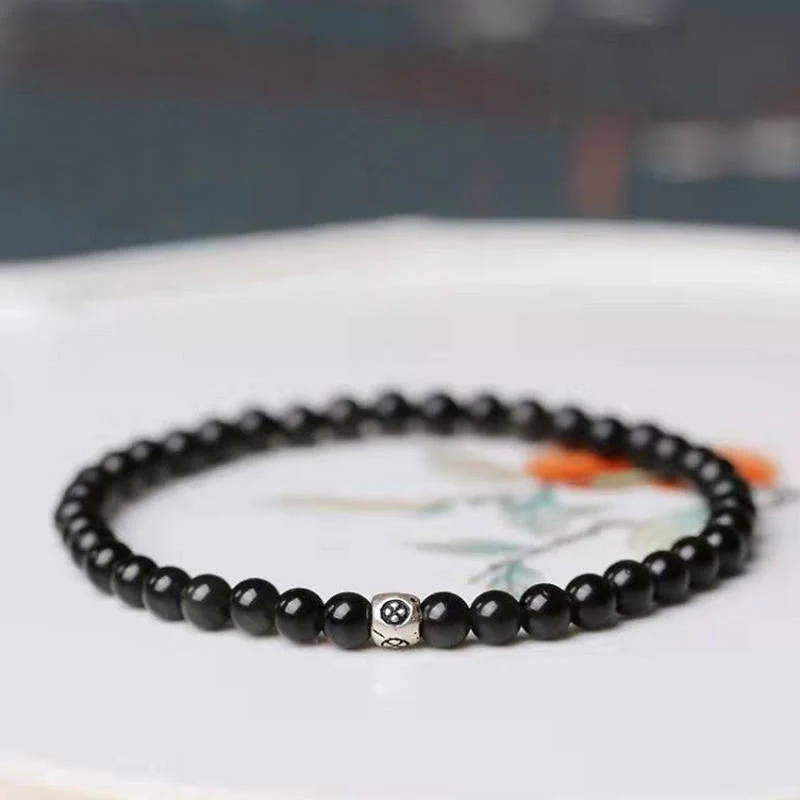Bracciale Buddha Stones in ossidiana nera naturale e quarzo fumé per la forza di purificazione