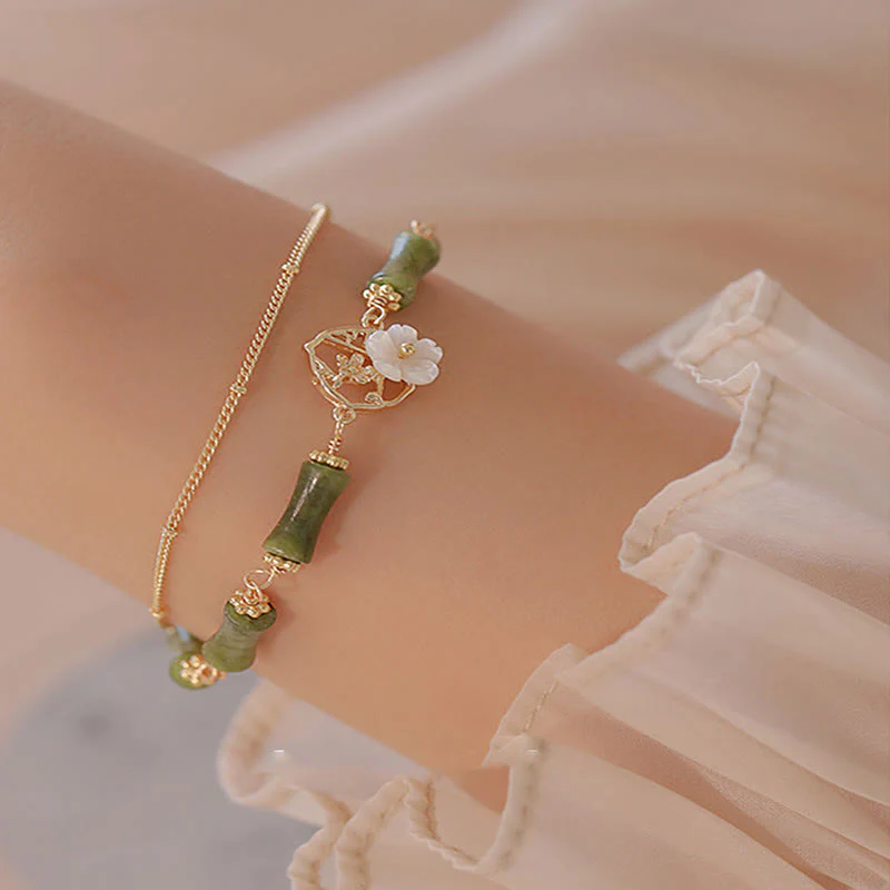 Bracciale Buddha Stones in rame placcato oro 14k con fiore di bambù, peridoto e doppio strato di ricchezza - Image 2