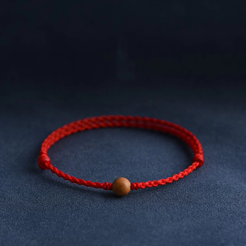 Bracciale intrecciato con perline di legno di pesca naturale Buddha Stones che allontanano gli spiriti maligni
