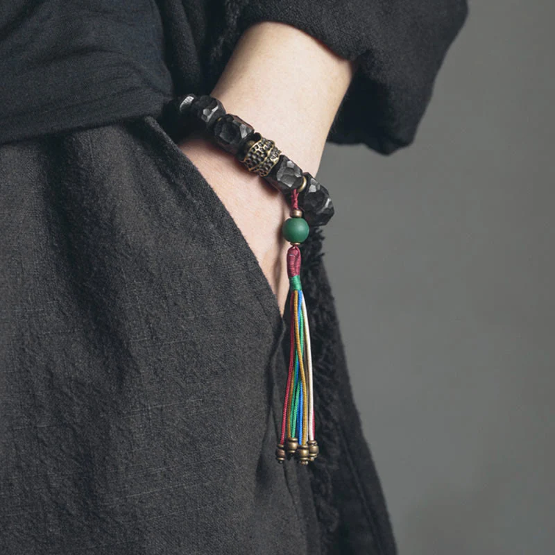 Bracciale Mala da polso con nappa in legno di Buddha Stones tibetano e rame della pace - Image 2