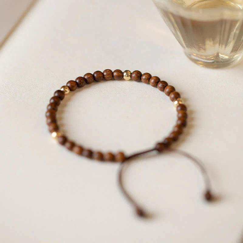 Braccialetto di protezione con perline di rame placcate in oro 14K e legno di sandalo ultrasottile da 4 mm Buddha Stones - Image 2