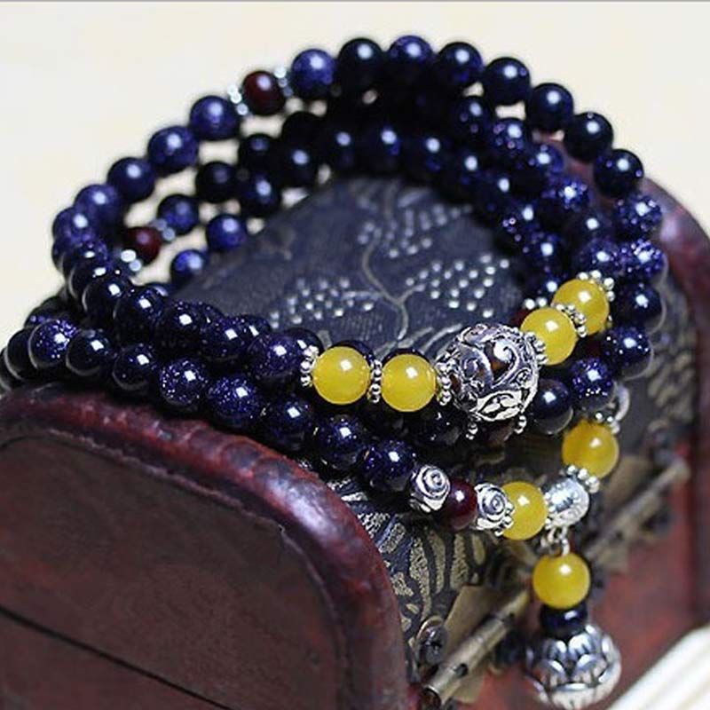 Braccialetto Mala con ciondolo di ricchezza in arenaria blu Buddha Stones