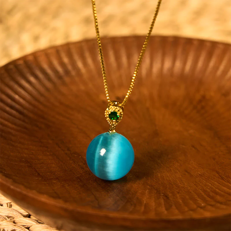 Buddha Stones Collana con ciondolo a forma di palla rotonda con occhio di gatto e simbolo di fiducia